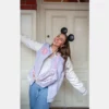 girl is wearing disney clover lane blue varsity jacket