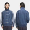 Blue Adidas Tang suede jacket with toggle closure, stand-up collar, and stripes running from collar to sleeve hem.