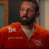 Bright orange Ben Affleck DunKings tracksuit, showcasing an aesthetic filled with Dunkin’ Donuts-inspired logos and playful motifs