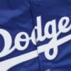 Close-up of the glossy satin fabric and LA Dodgers logo on the blue jacket.