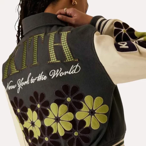 Detailed shot of the button-front closure on the Kith Women’s floral varsity jacket.