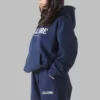 Side angle of the blue oversized hoodie, showcasing its boxy silhouette and dropped shoulders