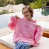 Cozy oversized pink hoodie with signature Glow House logo.
