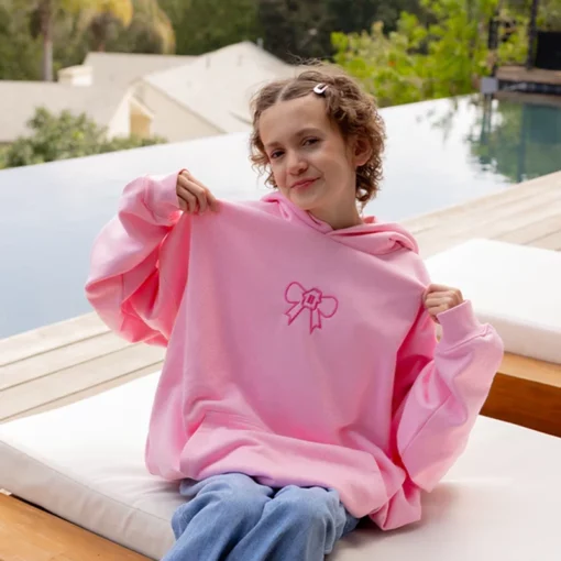 Cozy oversized pink hoodie with signature Glow House logo.