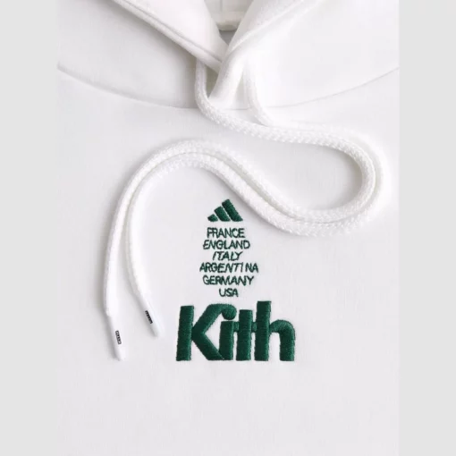 Minimalist white hoodie with Adidas stripes and Kith branding.