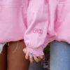 Stylish pink hoodie for women with oversized streetwear vibe.