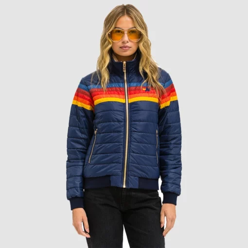 Bright stripe puffer coat worn by Isabela Merced
